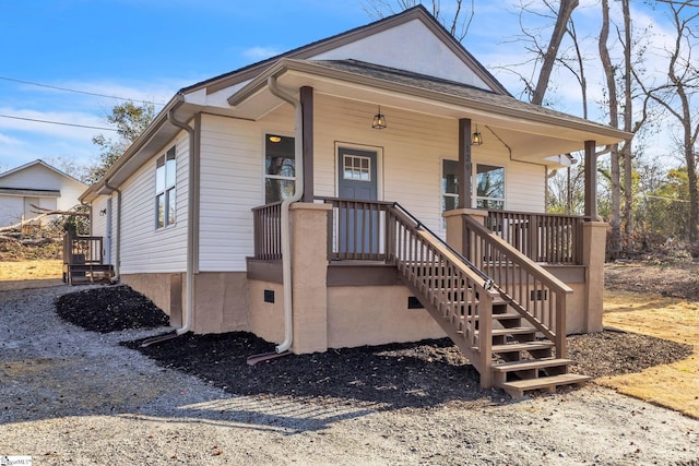 bungalow-style house featuring covered porch and stairway