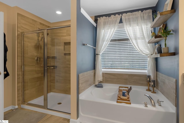 full bathroom with a garden tub and a shower stall