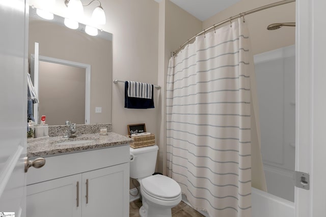 bathroom featuring toilet, shower / bath combo, and vanity