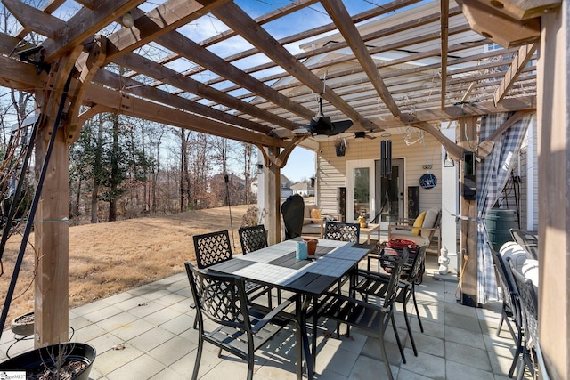 view of patio featuring ceiling fan, a pergola, and outdoor dining space