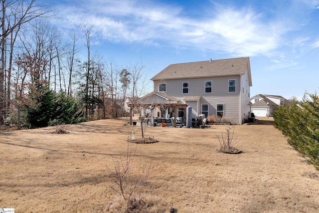 back of property with a gazebo