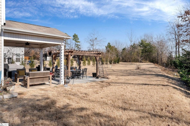 view of yard with a ceiling fan, a pergola, and a patio