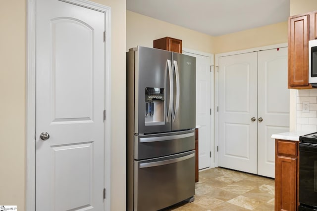 kitchen featuring appliances with stainless steel finishes, brown cabinets, light countertops, and tasteful backsplash