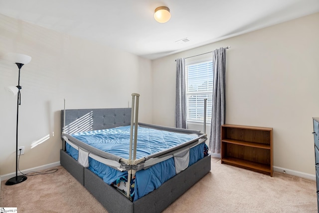 carpeted bedroom with visible vents and baseboards