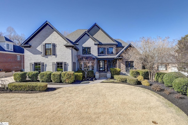 french country home featuring a front yard