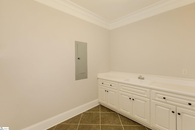 bathroom with crown molding, vanity, electric panel, baseboards, and tile patterned floors