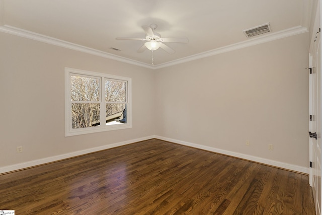 unfurnished room with baseboards, visible vents, dark wood-style flooring, and ornamental molding