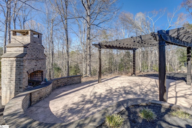 view of patio with an outdoor brick fireplace and a pergola