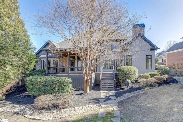 view of front of house with stairs and a chimney