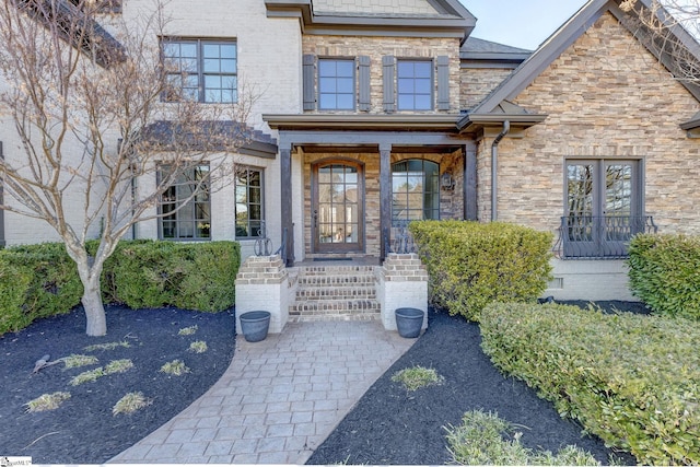 view of exterior entry featuring stone siding