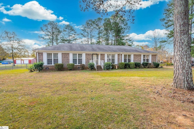 ranch-style home featuring crawl space, fence, a front lawn, and brick siding