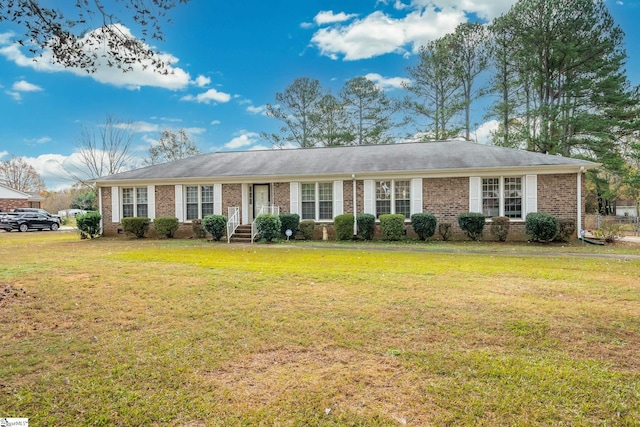 ranch-style home featuring brick siding and a front yard