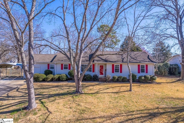 ranch-style home featuring a carport, driveway, and a front lawn