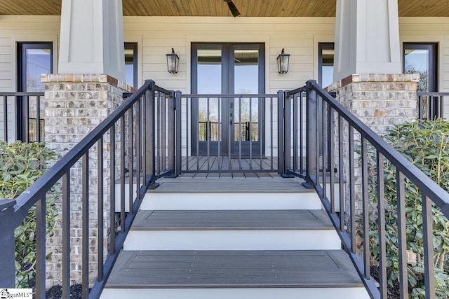 entrance to property with a ceiling fan and french doors