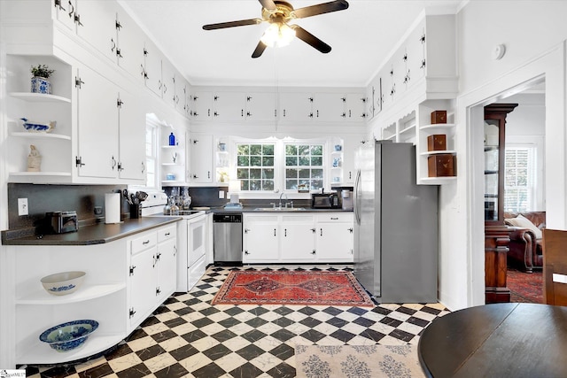 kitchen featuring dark countertops, stainless steel appliances, white cabinetry, and open shelves