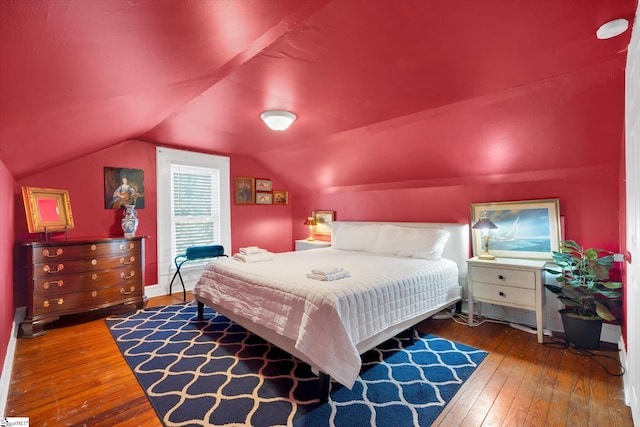 bedroom featuring lofted ceiling and wood-type flooring