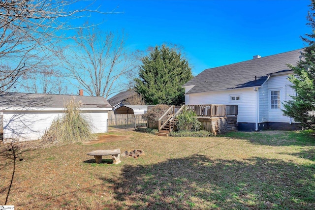 view of yard featuring fence, a deck, and stairs