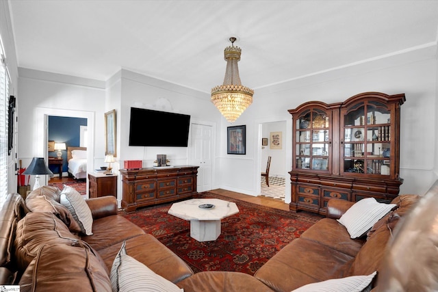 living area with an inviting chandelier and wood finished floors