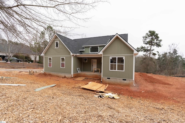 view of front of home with covered porch, a shingled roof, and crawl space