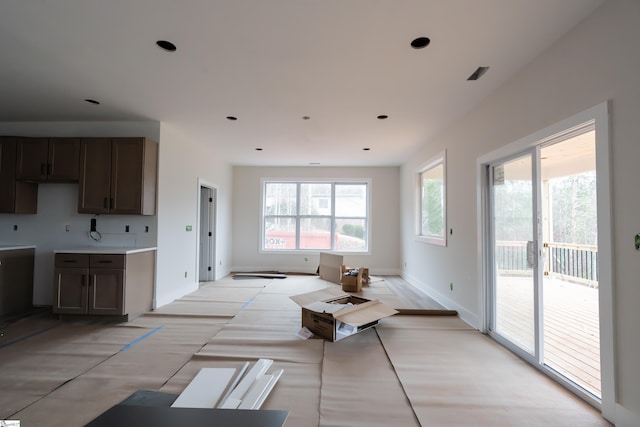 interior space featuring a healthy amount of sunlight, baseboards, visible vents, and light countertops