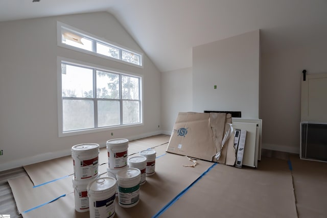 interior space with lofted ceiling and baseboards