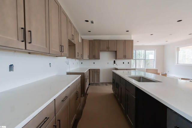 kitchen featuring recessed lighting, light countertops, and a sink