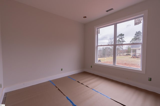 spare room featuring visible vents and baseboards