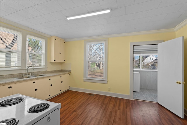 kitchen with white electric stove, light countertops, ornamental molding, and dark wood finished floors