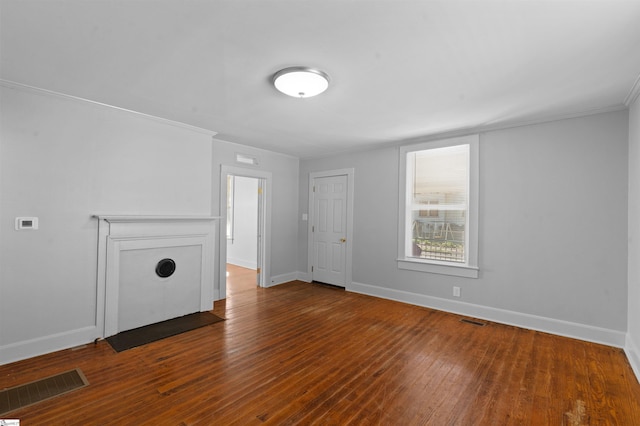 unfurnished living room featuring dark wood-style floors, visible vents, and baseboards