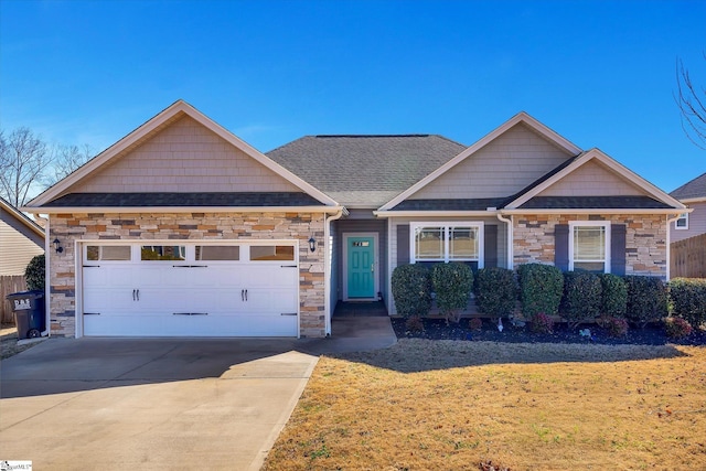 craftsman-style house with a garage, concrete driveway, roof with shingles, and stone siding