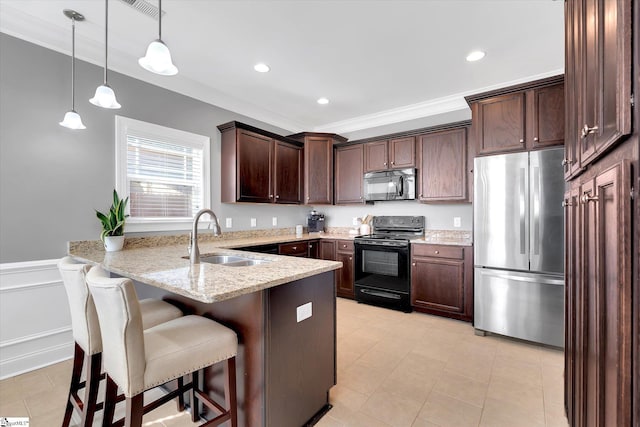 kitchen with light stone counters, hanging light fixtures, a sink, a peninsula, and black appliances