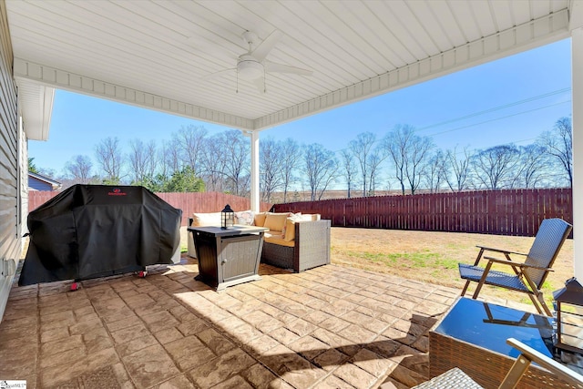 view of patio with a fenced backyard, grilling area, a ceiling fan, and an outdoor living space with a fire pit