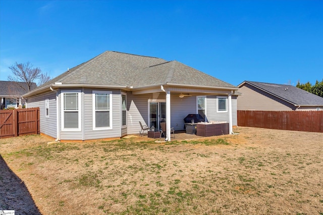 back of house with an outdoor hangout area, a yard, a shingled roof, and a fenced backyard