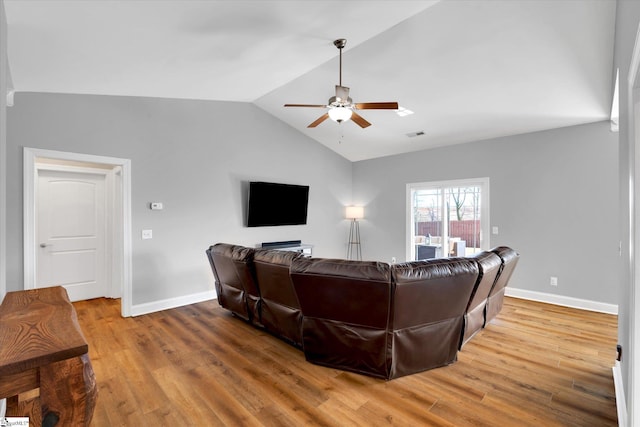 living room with vaulted ceiling, wood finished floors, a ceiling fan, and baseboards