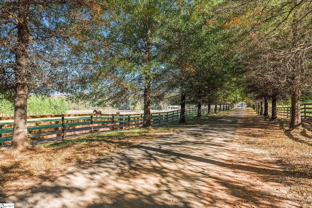 view of property's community featuring a rural view and fence