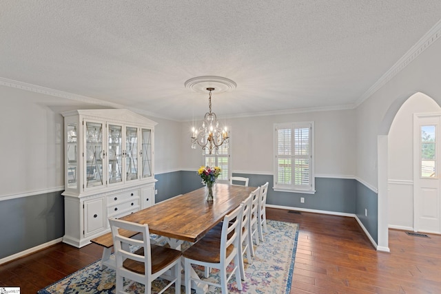 dining room featuring baseboards, plenty of natural light, arched walkways, and dark wood-type flooring