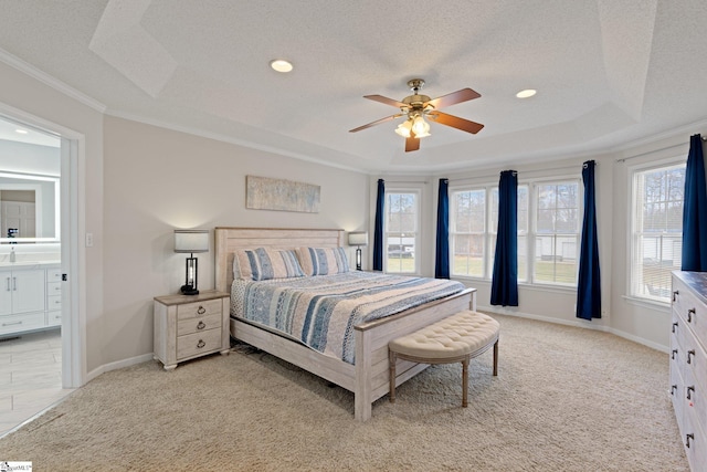 bedroom with a textured ceiling, multiple windows, a raised ceiling, and light colored carpet