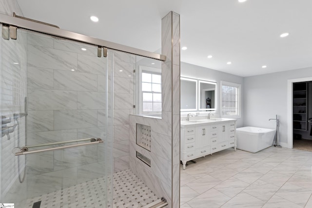 bathroom with a soaking tub, a sink, and a shower stall