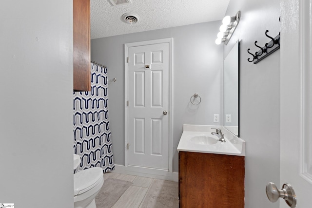 full bathroom with visible vents, toilet, vanity, and a textured ceiling