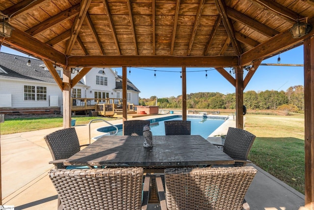 view of patio / terrace with an outdoor pool, a jacuzzi, a deck, and a gazebo