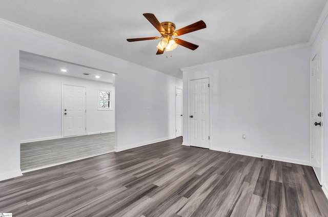 spare room with ceiling fan, ornamental molding, wood finished floors, and baseboards