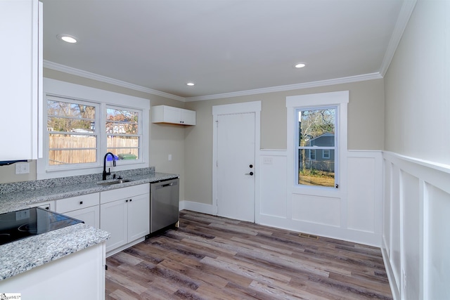 kitchen with dishwasher, light wood-style flooring, light stone countertops, white cabinetry, and a sink