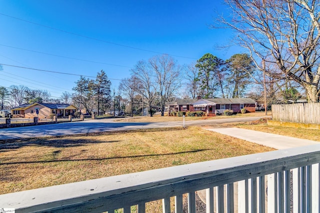 view of yard featuring a residential view and fence