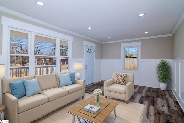 living area with recessed lighting, wainscoting, crown molding, and wood finished floors