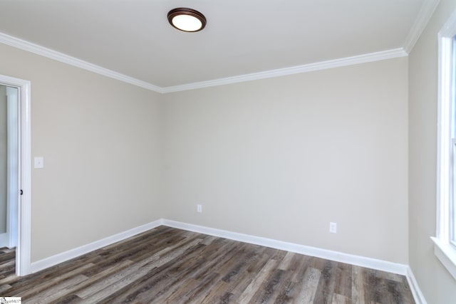 unfurnished room with dark wood-type flooring, ornamental molding, and baseboards