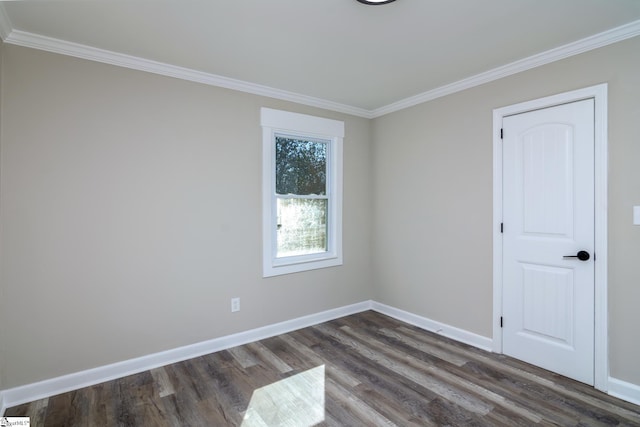 unfurnished room with baseboards, dark wood-type flooring, and ornamental molding