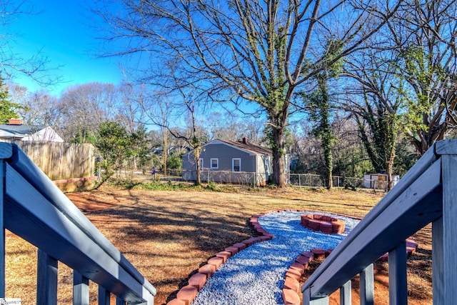 view of yard with a fenced backyard and a fire pit