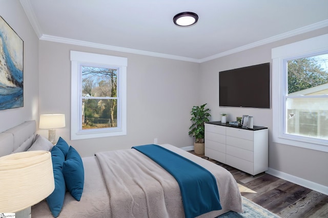 bedroom with baseboards, wood finished floors, and crown molding