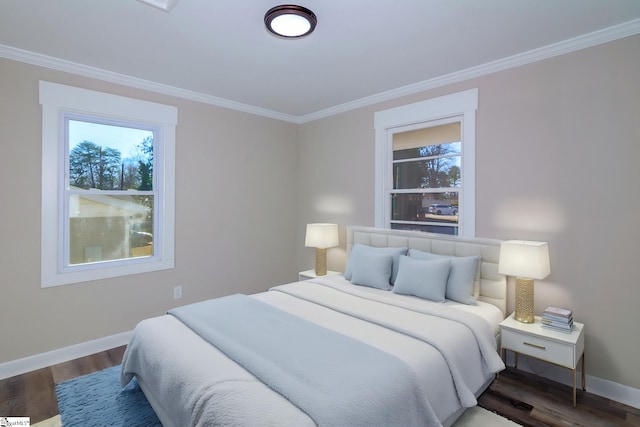 bedroom with dark wood-style floors, crown molding, and baseboards