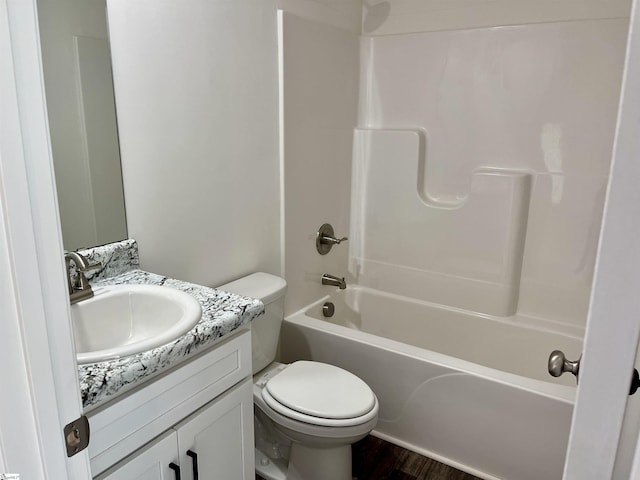 full bathroom featuring toilet, shower / bath combination, wood finished floors, and vanity